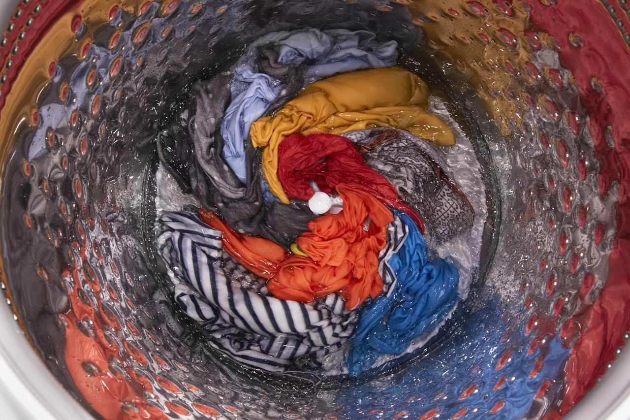 interior of washing machine with clothes spinning